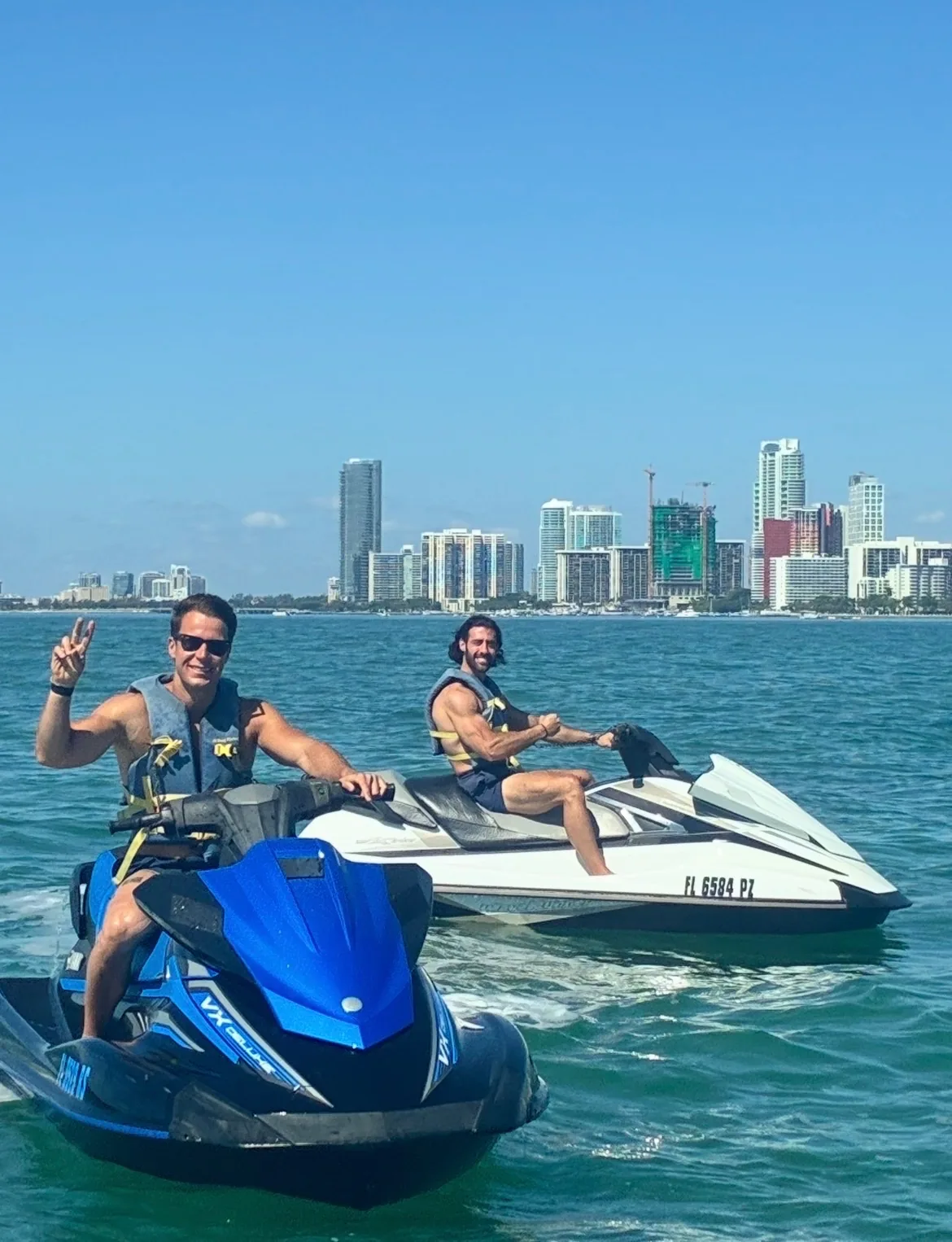 Riders on jet skis with Miami skyline in background